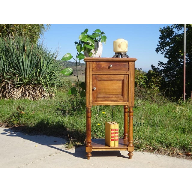 Very old bedside table, traditionally made in France from solid walnut, late 19th century. Brown marble top with white...