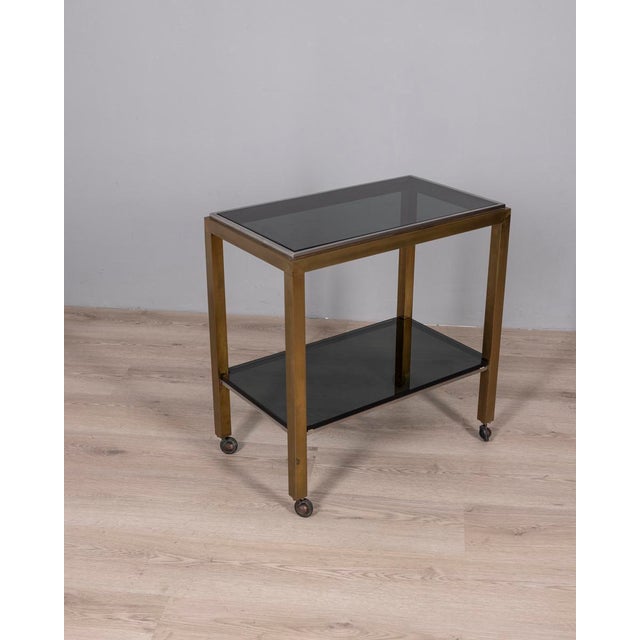 Trolley with gilded brass and chromed metal structure, with two smoked glass shelves, Italian design, 1970s.