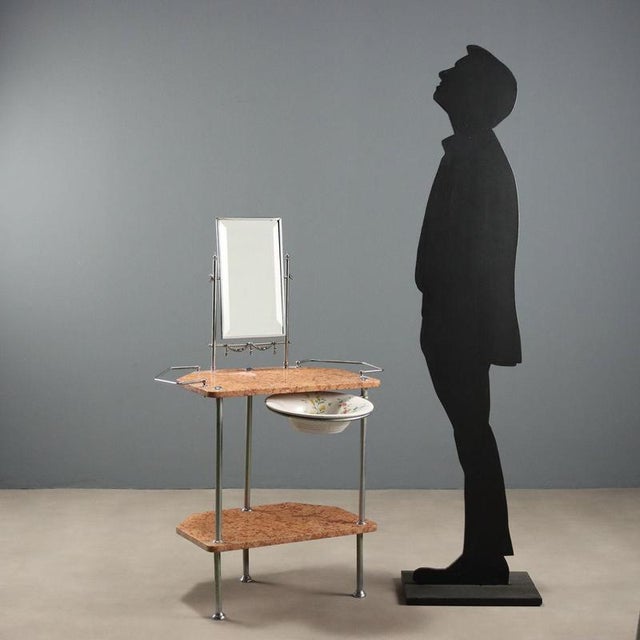 20th-century Italian vanity, featuring an elegant balance between metal and marble. The chrome metal structure supports a...