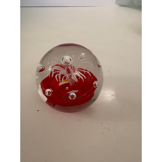 This Murano clear hand blown glass sphere engulfing a red artistic rose sprouting a beautiful feathery multi-armed white...