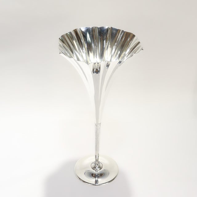 A fine signed, antique trumpet form flower vase. By Tiffany & Co. In sterling silver. With a fluted trumpet shaped top,...