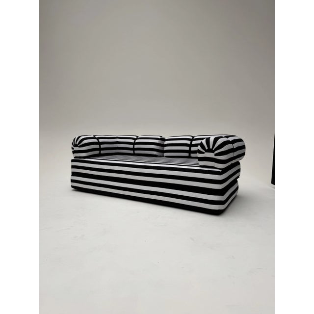 Vintage black and white striped sofa bed in very good condition. Entirely made of foam. This piece has an attribution...