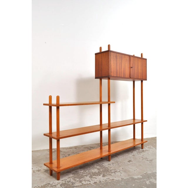 Room divider This 1950s shelving unit features a combination of oak and beech wood, along with a mahogany cabinet section...