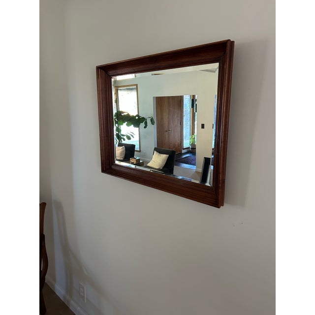 Vintage Uttermost mirror made in Rocky Top, Virginia. Beautiful thick wood frame with large beveled mirror.