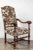 Beautifully carved, Italian, walnut chairs featuring serpentine arms terminating in lion's heads with flowing manes. Each...