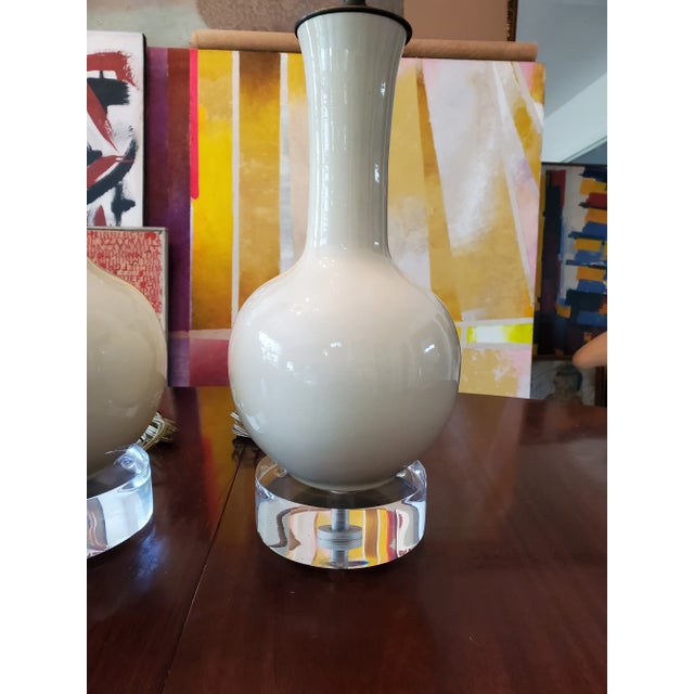 A very high end designer vintage pair of cream porcelain and lucite lamps. A true mid century modern Era original ( circa...