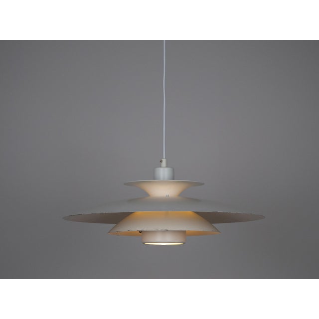 This lamp was designed by Danish designer Kurt Wiborg and manufactured by Jeka. The lamp's form is based on the principle...