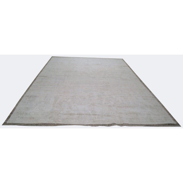 Hand-knotted with care using traditional rug-making techniques, this wool rug blends timeless craftsmanship with a modern...