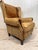 Elevate your space with this striking vintage wingback armchair, exuding character and timeless style. Crafted from rich...