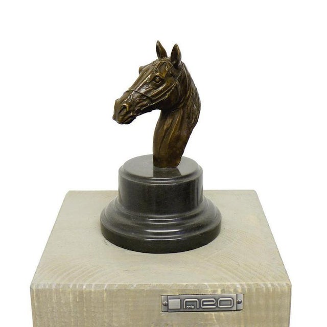 Art Deco style bronze horse head sculpture in dark patinated bronze, mounted on a circular base and square plinth. This...