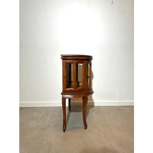 This elegant vintage display cabinet combines graceful craftsmanship with practical functionality. Made from beautifully...