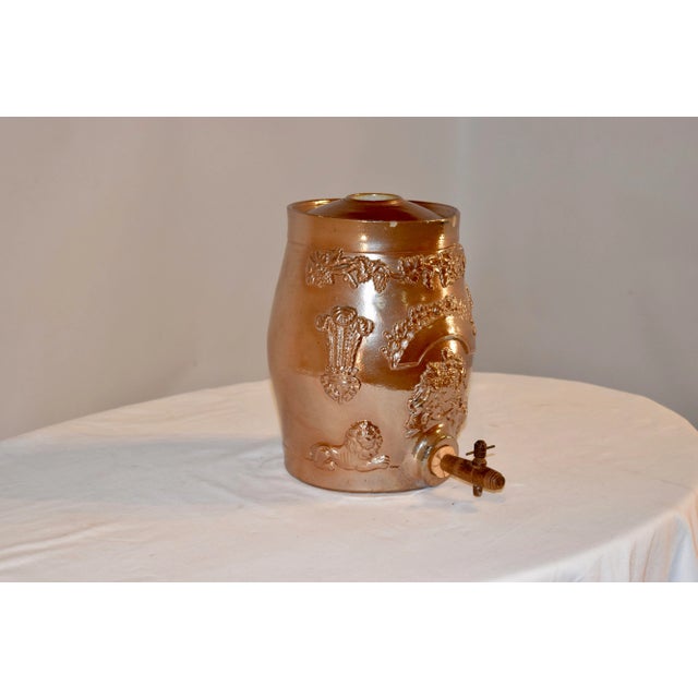 Victorian alkaline glazed stoneware spirit barrel from England. There is all-over applied decoration. In the front there...