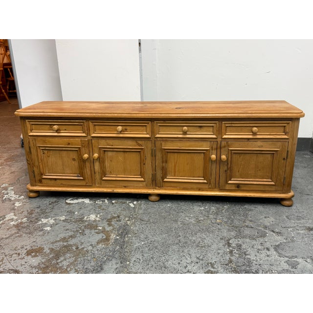 Design Plus Gallery presents an Antique European Pine Four-Door Sideboard, Circa 1830. Dating to the early 19th century,...