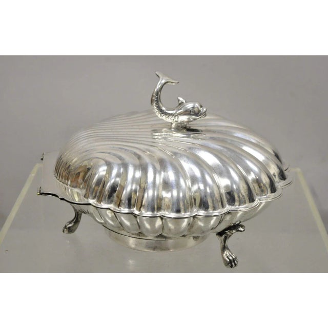 Vintage Eton Dolphin Handle Clam Shell Silver Plate Electrified Bun Warmer. Item featured is raised on 3 paw feet, smiling...