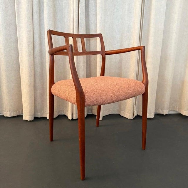 An exceptional Danish modern design classic, the Møller no. 64 captain's dining armchair in teak wood was created in the...