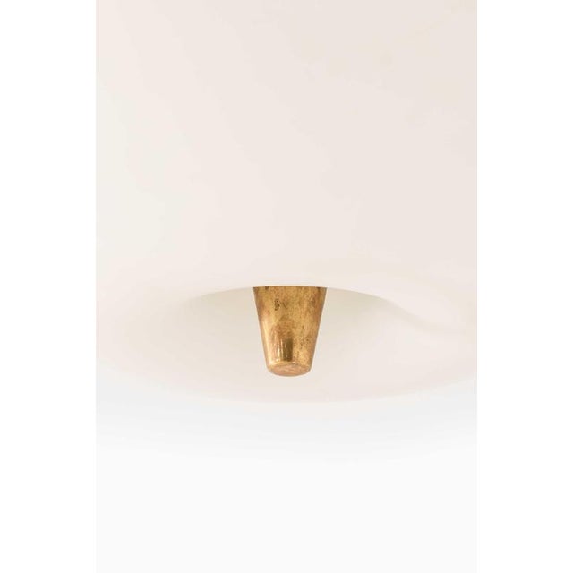 The very rare ceiling lamp model 71-125, designed by Lisa Johansson-Pape and produced by Stockmann-Orno in Finland,...