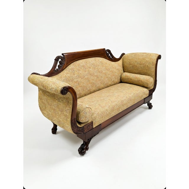 Elevate your parlor or living space with this exquisite antique American Empire settee, a timeless piece that blends...