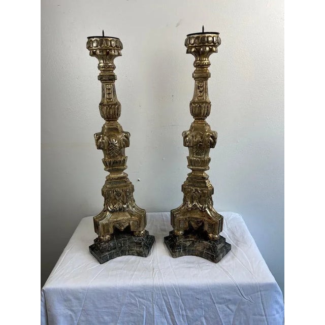 Early 20th Century pair of Italian silver & gold gilt candlesticks. There is some wear to the gilt finish but overall they...