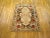 Antique Portuguese needlepoint flat-weave rug handwoven with a symmetrical floral design, ivory center, and bold splashes...