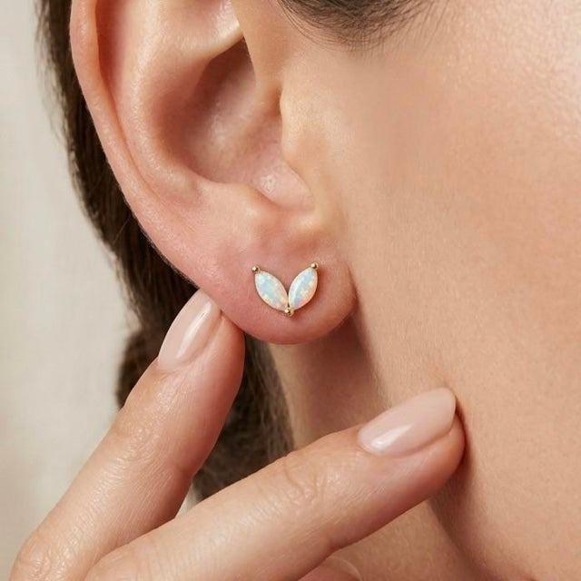 Enhance your jewellery collection with these charming leaf-inspired stud earrings featuring a graceful dual marquise...