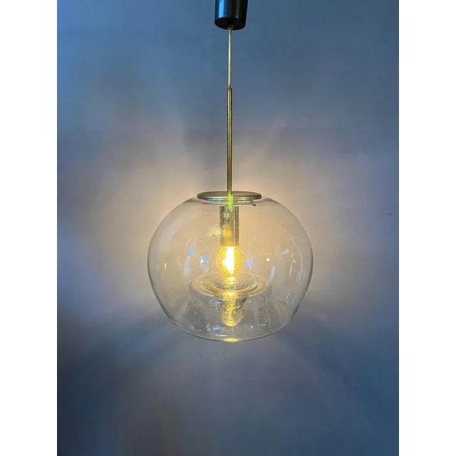 Very rare glass pendant the German Doria Leuchten. The hand-made glass is beautifully shaped with a bulb-movement...