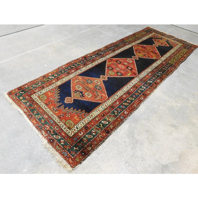 Four geometric medallions on deep blue background. Four striped border with floral decoration. Circa: 1930 Evenly worn...