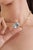This pendant necklace showcasing a captivating 10.32 carat natural oval aquamarine, beautifully set in 14K yellow gold....