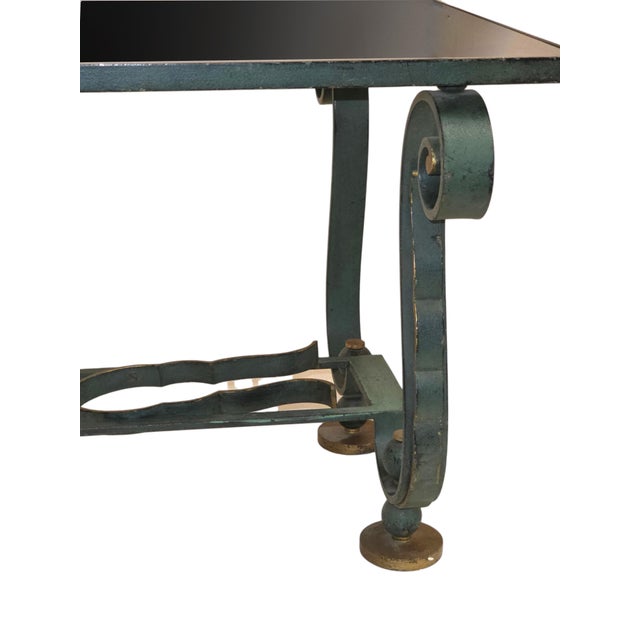 Elegant French 1940's coffee table with a hand‑wrought iron base in a rich verde gris patina, highlighted by gilt accents...