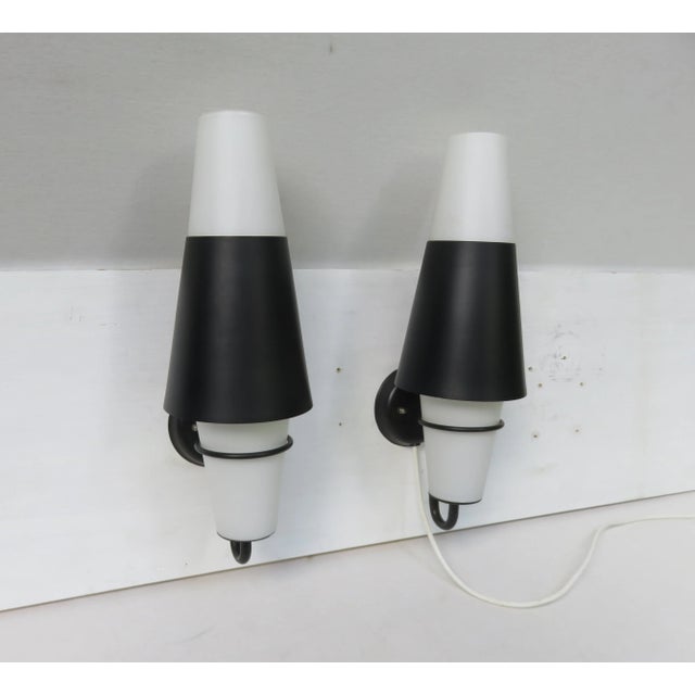 Great pair of wall lights from the 50s, Italy. The wall brackets and the Aufsteckschirme are painted metal black. The...