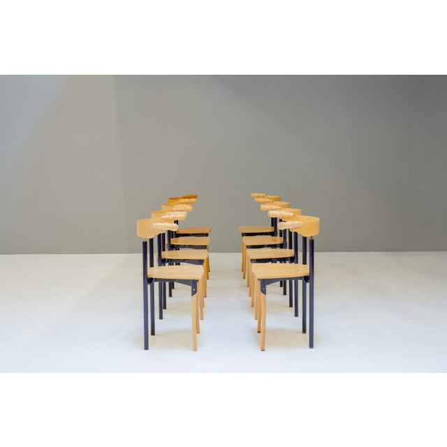 Rare set of 8 Jansky chairs, a solid steel and wood construction. The steel construction is in a dark purple, with brass...