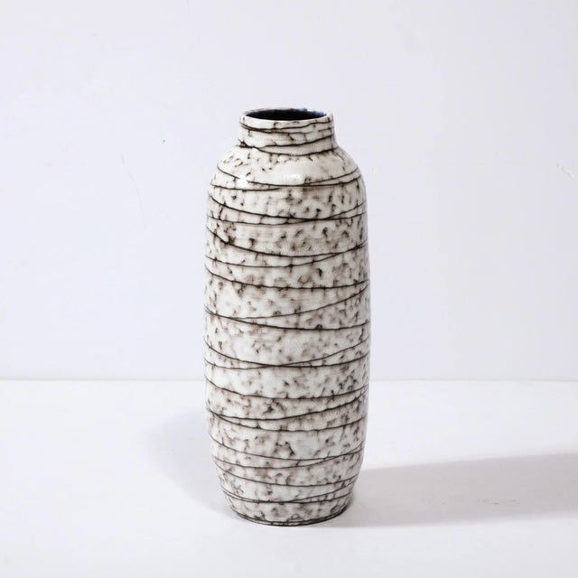 This Mid-Century Modernist Horizontally Striated Ceramic Vase is a beautiful example of Post War European Ceramics,...