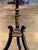 A striking Regency candlestand in ebonized and gilt wood, with a shaped rectangular top decorated in chinoiserie — the...