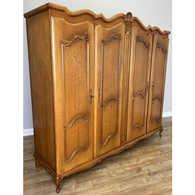 This elegant Vintage French Louis wardrobe presents a beautifully shaped silhouette with flowing lines, ornate carved...