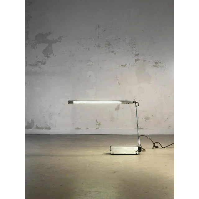 A rare table lamp, post-modernist, kinetics, radical design, minimalist, rectangular base in the aluminum hood housing a...