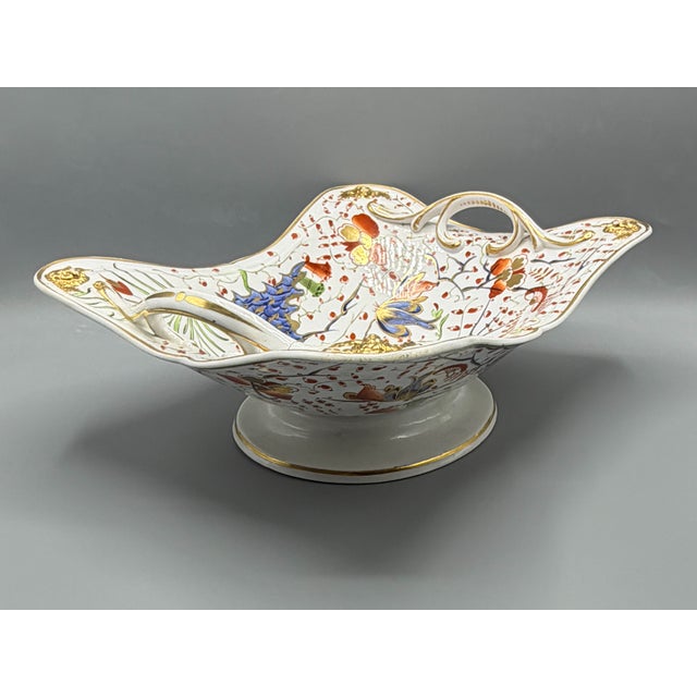 A rare antique decorative example early 19th-century derby porcelain, this impressive centrepiece basket combines the...