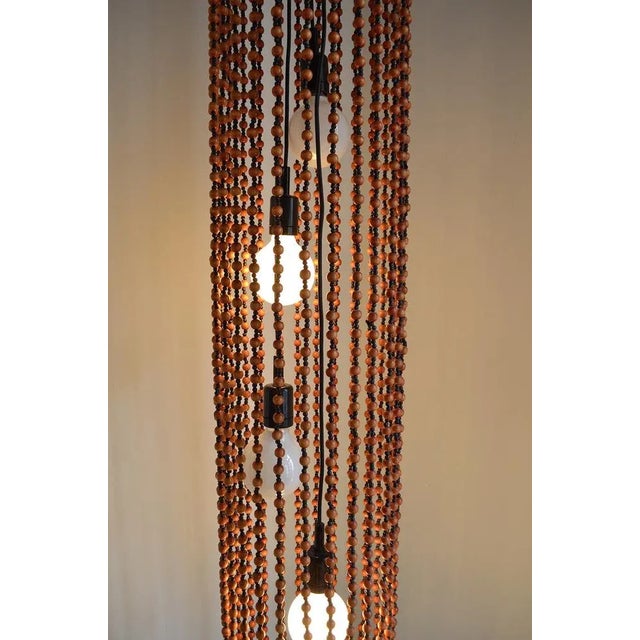 1960s Tiki design. The hanging lamp was produced by the German/Swiss company Temde - the lamp consists of countless wooden...