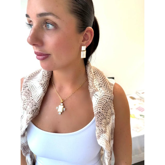 A mix of step cut Mother of Pearl paired with white topaz and a paperclip GF chain