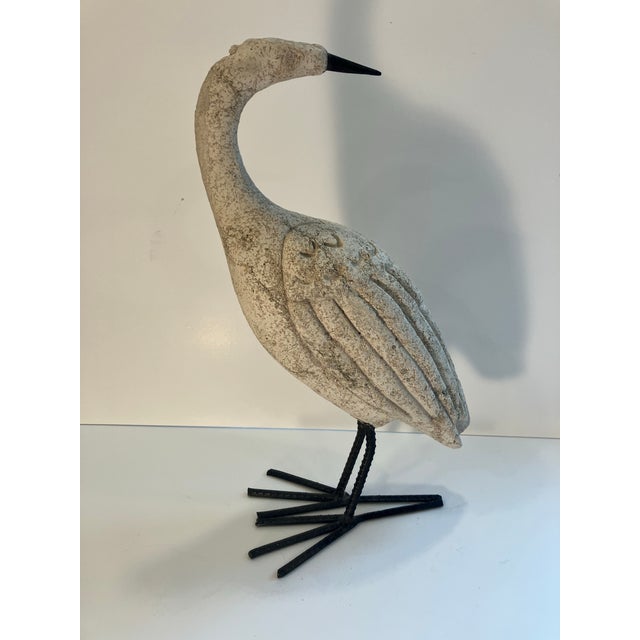 This bird sculpture is made of cast volcanic rock and iron suitable for exterior use. The volcanic rock came from an...