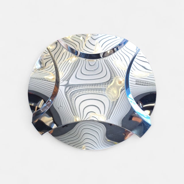 Large centerpiece designed by Enrico Panzeri for Robots Milano in the 1970s. Curved and mirror-polished steel. Maker's...