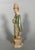 Statuette of a servant known as a "Mingqi," China - Ming Dynasty (1368-1644). Terracotta sculpture with green and brown...