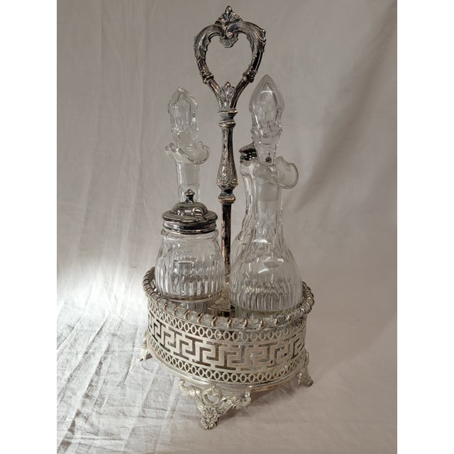 This stunning antique circa 1890 silverplate and crystal four round bottle cruet set features an elaborate and distinctive...