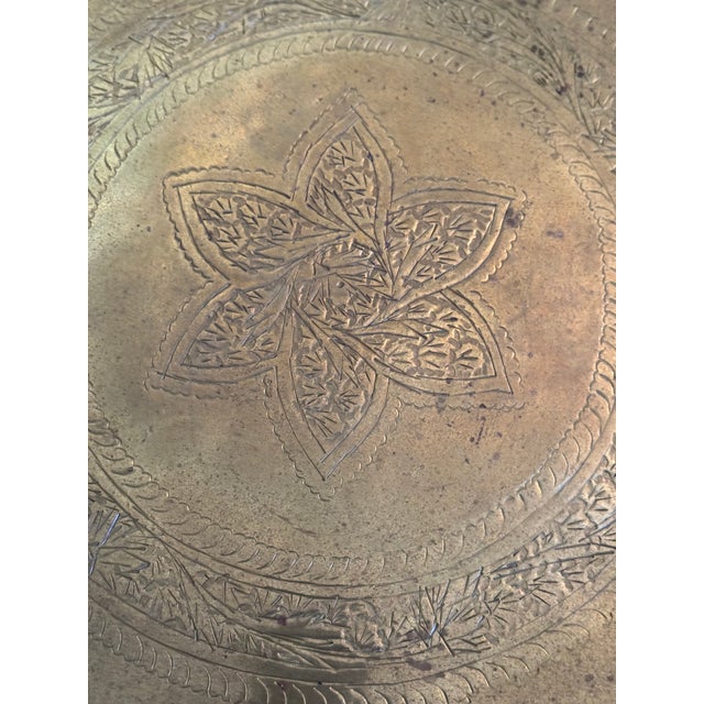 Cute small Moroccan engraved brass tray on collapsible wooden stand.