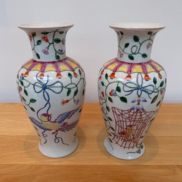 A delightful pair of hand-painted porcelain vases by Altfield Hong Kong, featuring whimsical chinoiserie decoration in a...