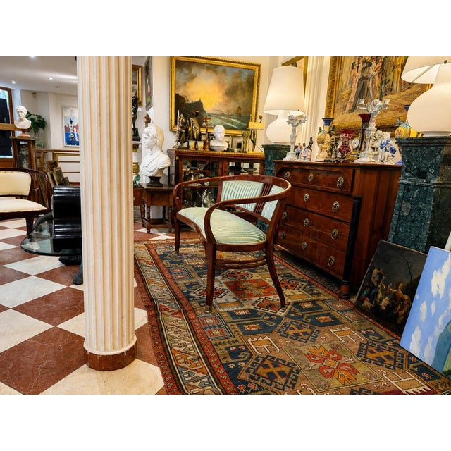 An elegant Austrian Jugendstil settee from the early 20th century, executed in the refined and restrained aesthetic...