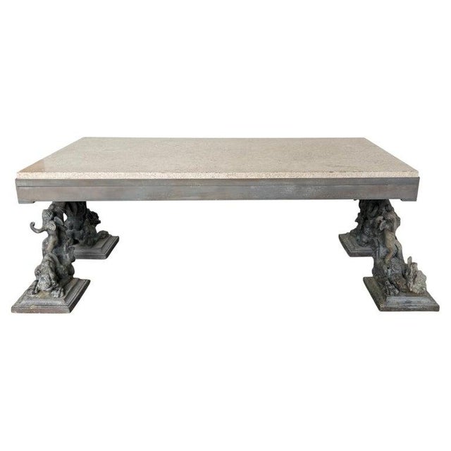 Bronze Figural Coffee Table with Travertine Top A unique and sculptural bronze coffee table featuring a pair of cast...