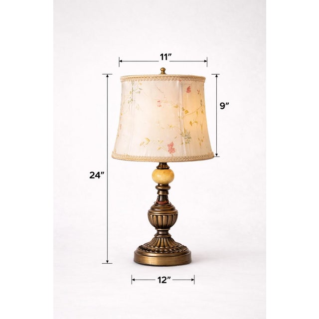 Elegant vintage urn-form table lamps with rich patina and original hand-painted floral silk shades, offering a warm,...