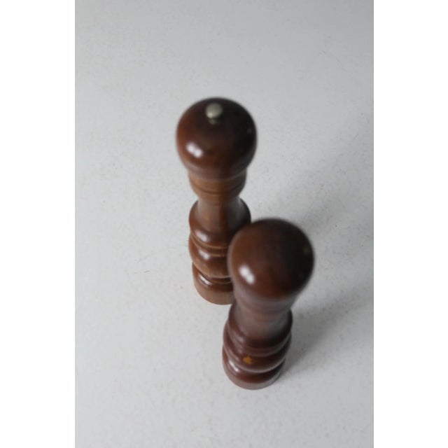 This is a mid 20th century vintage salt shaker and pepper mill. The wooden set has a turned baluster design and tone. 11"...