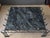 This sculptural coffee table features a deep, teal-green marble slab top on a curly, scalloped metal base with a faux...