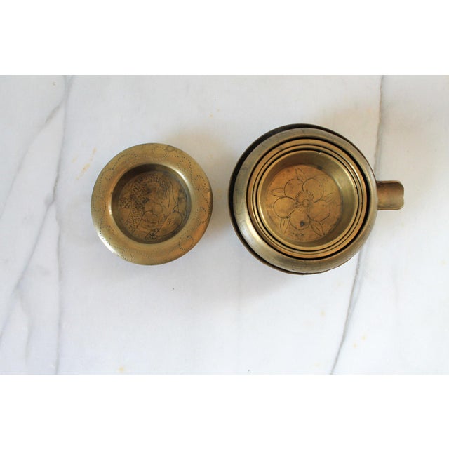 Set of six vintage Chinese etched brass nesting ashtrays. Makers mark is stamped on 2 of the pieces. Age wear.