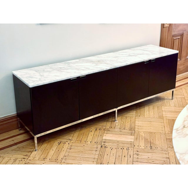 Florence Knoll Four-Position Credenza in Ebonized Oak on a Polished Chrome base with a Polished Calacatta marble top....